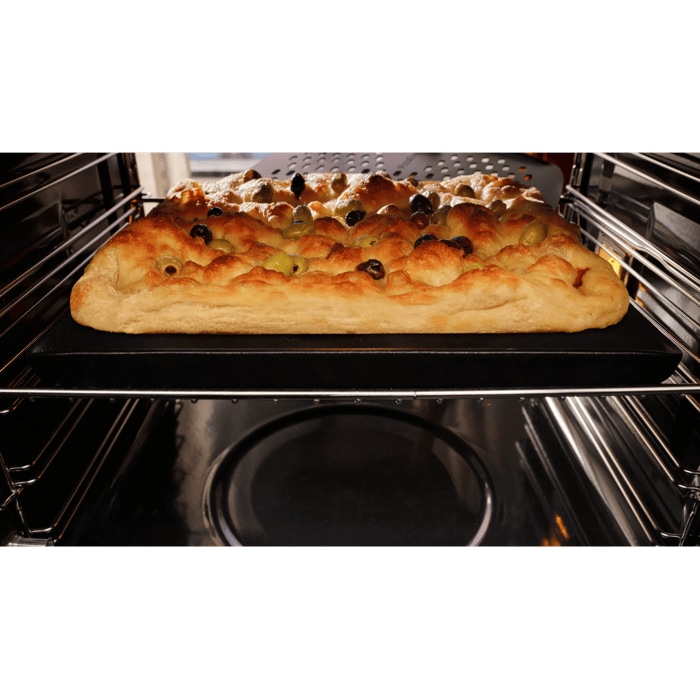 Focaccia baked inside oven taken out with pizza peel 