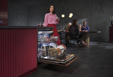 Woman unloading dishwasher
